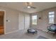Neutral bedroom featuring a ceiling fan, bright windows and sliding closet doors at 24556 E Ottawa Ave, Aurora, CO 80016