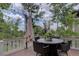 Inviting outdoor deck with patio furniture, an umbrella for shade, and string lights creating a cozy atmosphere at 24556 E Ottawa Ave, Aurora, CO 80016