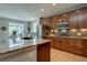 Spacious kitchen with dark wood cabinets, granite countertops, and stainless steel appliances at 24556 E Ottawa Ave, Aurora, CO 80016