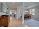 Bright, open-concept space showcasing hardwood floors and columns with views of the living room and dining area at 24556 E Ottawa Ave, Aurora, CO 80016