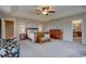 Bright main bedroom boasts a wooden bed frame and a view into the en-suite bathroom at 24556 E Ottawa Ave, Aurora, CO 80016