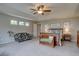 Spacious main bedroom features a tray ceiling, ceiling fan, and a seating area at 24556 E Ottawa Ave, Aurora, CO 80016