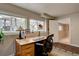Home office featuring a built-in desk, a large window and hardwood flooring at 24556 E Ottawa Ave, Aurora, CO 80016
