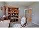 Home office with a decorative bookshelf and comfortable seating at 24556 E Ottawa Ave, Aurora, CO 80016