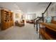 Finished basement with carpeted floor, large seating area, and stair access to upper level at 355 Steele St, Denver, CO 80206