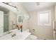 Bathroom with neutral walls, large mirror, and shower with glass doors at 355 Steele St, Denver, CO 80206