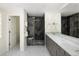 Elegant bathroom with gray vanity, spacious shower with glass door, and herringbone floor at 355 Steele St, Denver, CO 80206