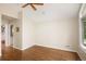 Bedroom featuring neutral walls, hardwood floors, ceiling fan, and a large window at 355 Steele St, Denver, CO 80206