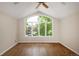 Spacious, sun-filled bedroom with a ceiling fan, hardwood floors and large window providing lots of natural light at 355 Steele St, Denver, CO 80206