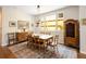 Charming dining room with vintage furniture and a large window for natural light at 355 Steele St, Denver, CO 80206