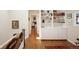 Upstairs hallway with hardwood floors, built in shelves, and view into primary bedroom at 355 Steele St, Denver, CO 80206