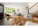 Sun-filled living room with hardwood floors, large windows, staircase, and stylish decor at 355 Steele St, Denver, CO 80206