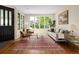 Bright living room with hardwood floors, a large window and stylish decor at 355 Steele St, Denver, CO 80206