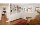 Bright office with a built-in bookcase, colorful stained glass window, and hardwood floors at 355 Steele St, Denver, CO 80206