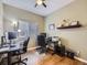 Home office with wood floors, built-in shelving, and two workstations at 10172 Meadowbriar Ln, Highlands Ranch, CO 80126