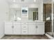 Bathroom with double vanity, white cabinets, and separate glass shower enclosure at 2070 Wagon Wheel Aly, Brighton, CO 80601