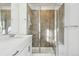 Modern bathroom featuring a glass-enclosed shower with tiled walls and a vanity with a sink at 2070 Wagon Wheel Aly, Brighton, CO 80601
