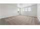 Bright bedroom with neutral carpet and three windows providing natural light at 2070 Wagon Wheel Aly, Brighton, CO 80601