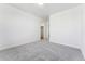 A bright bedroom has neutral walls, carpet, and doorway to a walk-in closet at 2070 Wagon Wheel Aly, Brighton, CO 80601