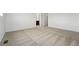 Well-lit bedroom featuring neutral carpet leading to an open entryway at 2070 Wagon Wheel Aly, Brighton, CO 80601