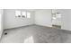 Bedroom featuring neutral carpet, three windows, and an ensuite bathroom at 2070 Wagon Wheel Aly, Brighton, CO 80601