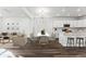 Open-concept living and dining area with stylish decor, ample seating, and a modern kitchen at 2070 Wagon Wheel Aly, Brighton, CO 80601