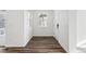 Hallway featuring wood-look flooring, neutral walls, and a view of the front door at 2070 Wagon Wheel Aly, Brighton, CO 80601