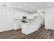 Well-lit kitchen with white cabinets, stainless steel appliances, and wood-look floors at 2070 Wagon Wheel Aly, Brighton, CO 80601