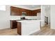 Beautiful kitchen with dark wood cabinets, white countertops, and a spacious center island perfect for cooking at 2070 Wagon Wheel Aly, Brighton, CO 80601