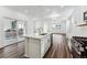 Modern kitchen with white cabinets, quartz countertops, and a large island with a sink at 2070 Wagon Wheel Aly, Brighton, CO 80601