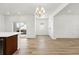 Bright living room features wood flooring, a modern chandelier, and access to outdoor space at 2070 Wagon Wheel Aly, Brighton, CO 80601