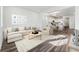 Bright, open-concept living space with stylish furniture and an eat-in kitchen at 2070 Wagon Wheel Aly, Brighton, CO 80601