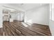 Bright living room with wood-look floors leading to the kitchen at 2070 Wagon Wheel Aly, Brighton, CO 80601