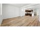 Spacious living room with light wood flooring and ample natural light open to the kitchen area at 2070 Wagon Wheel Aly, Brighton, CO 80601