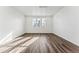 Bright living room featuring wood-look flooring, recessed lighting, and three large windows at 2070 Wagon Wheel Aly, Brighton, CO 80601