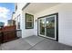 Private patio with sliding glass door and white siding at 2070 Wagon Wheel Aly, Brighton, CO 80601
