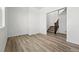 An open room features wood-look floors, a staircase, and neutral paint at 2070 Wagon Wheel Aly, Brighton, CO 80601