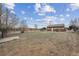 Large backyard featuring mature trees and fire pit at 7624 Navajo St, Denver, CO 80221