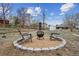 Backyard with a fire pit and chairs set in a gravel area with a surrounding brick border at 7624 Navajo St, Denver, CO 80221
