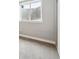 Basement view showing a window well, carpeting, and neutral wall color at 7624 Navajo St, Denver, CO 80221