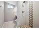 Bathroom with tiled shower, modern fixtures, and neutral color scheme at 7624 Navajo St, Denver, CO 80221