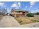 Charming home featuring a brick facade and manicured landscaping at 7624 Navajo St, Denver, CO 80221