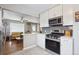 Well-designed kitchen with stainless steel appliances opening to living area at 7624 Navajo St, Denver, CO 80221