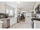 Bright kitchen with stainless steel appliances and seamless flow to living area at 7624 Navajo St, Denver, CO 80221