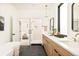Bright bathroom features a modern tub, glass shower, and wood vanity at 4398 N Pecos St, Denver, CO 80211
