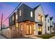 Modern two-story home showcasing a combination of brick and metal siding with ample natural light at twilight at 4398 N Pecos St, Denver, CO 80211