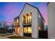 Striking exterior view of the modern home, emphasizing its architectural lines and contrasting materials against the evening sky at 4398 N Pecos St, Denver, CO 80211