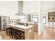 Gourmet kitchen featuring stainless steel appliances, a spacious island with bar seating, and custom cabinetry at 4398 N Pecos St, Denver, CO 80211