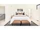 Bright main bedroom showcasing a stylish bed, accent bench, and side tables at 4398 N Pecos St, Denver, CO 80211