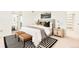 Bright main bedroom featuring a stylish bed, accent bench, and decorative rug at 4398 N Pecos St, Denver, CO 80211